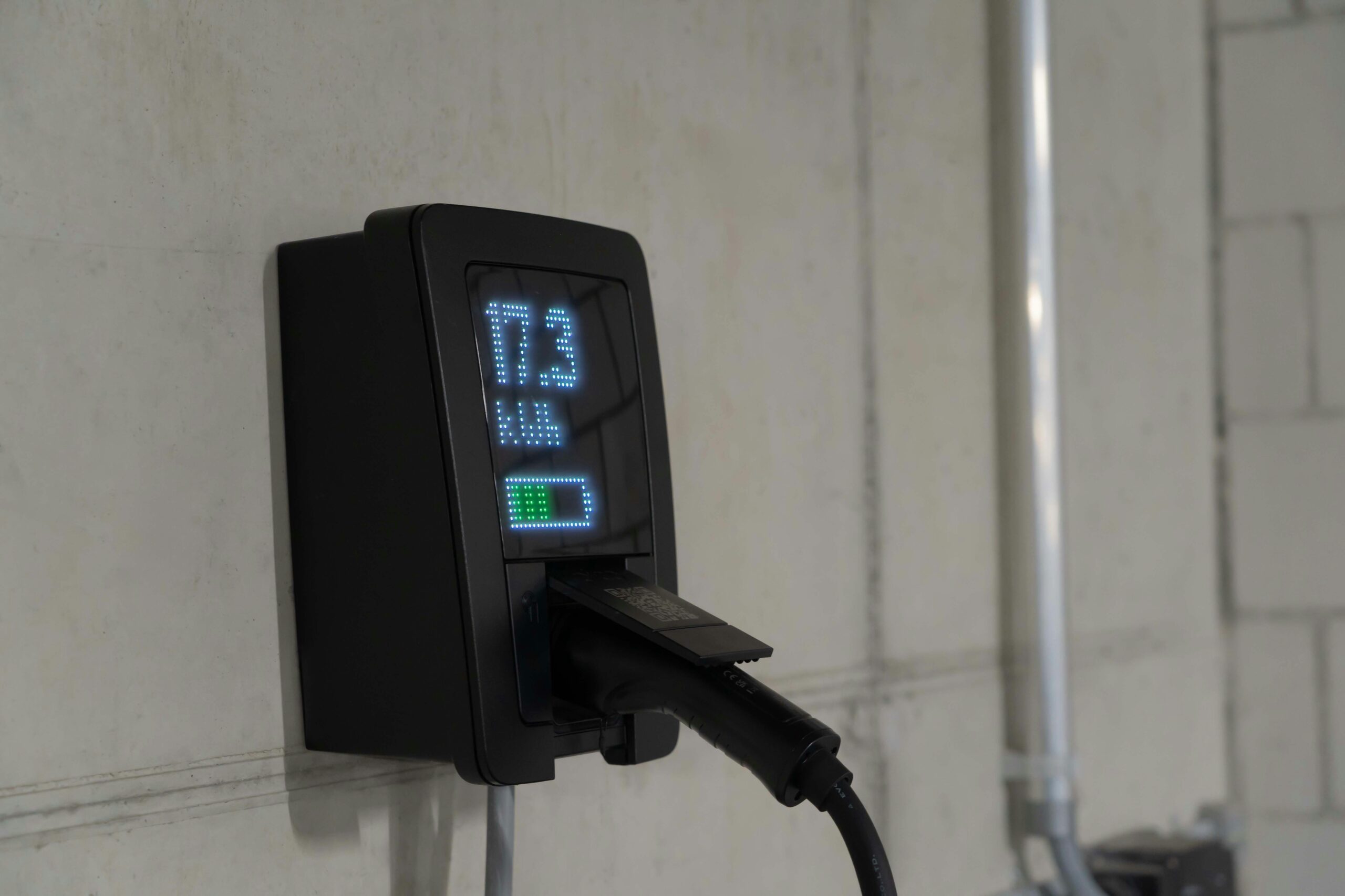 Detailed view of an electric vehicle charging station indoors, showcasing charging technology.