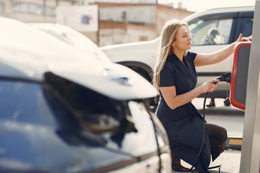 A woman charges her electric car at a city station, embracing eco-friendly travel.
