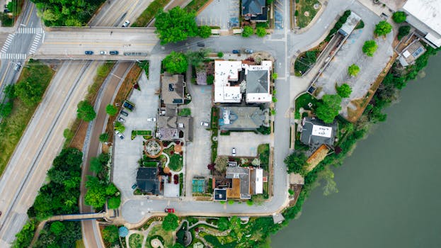 Aerial view of a residential area nestled by the river in Chattanooga, TN, showcasing roads and greenery.