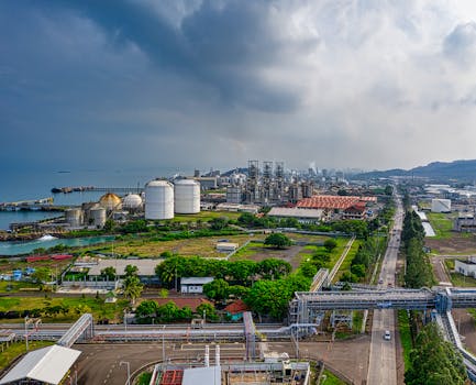 Aerial view of a coastal industrial area in Banten, Indonesia, with factories and overcast skies.