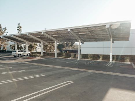 Solar panels installed over a parking lot, showcasing clean energy innovation outdoors.