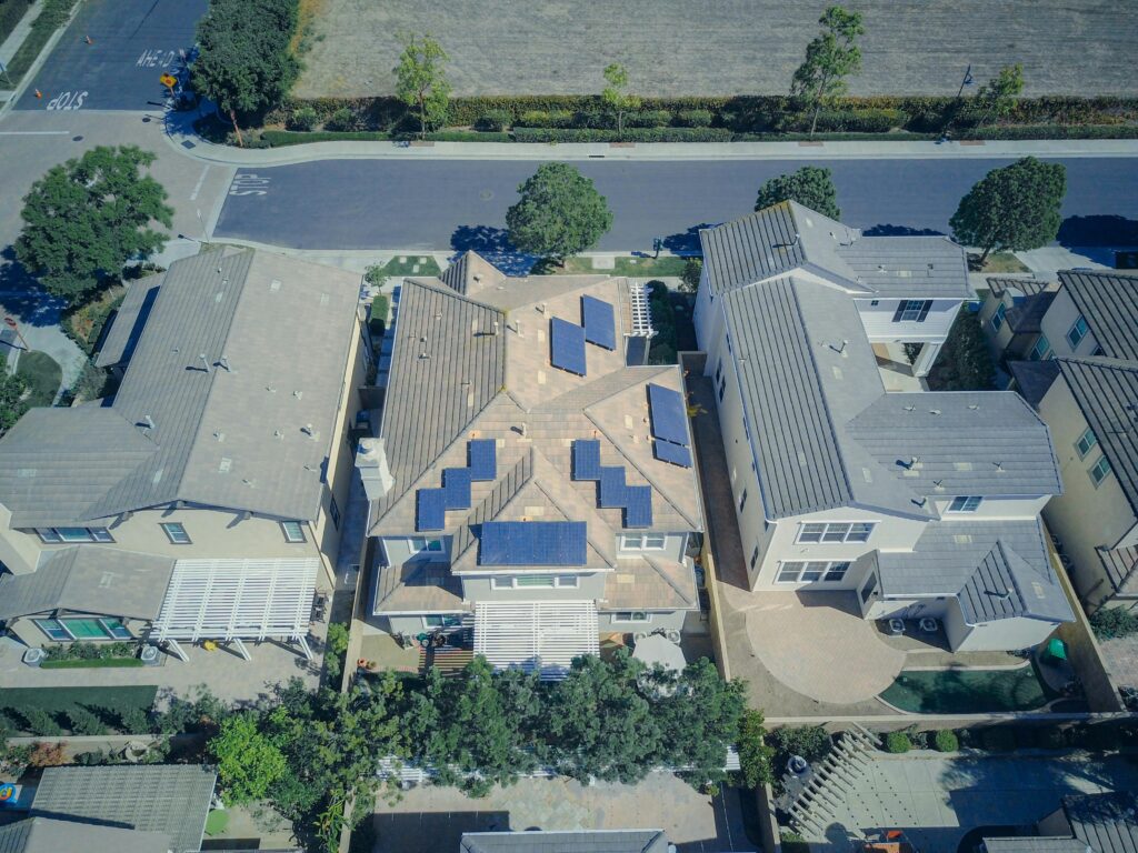 Aerial view of suburban houses equipped with solar panels for renewable energy.