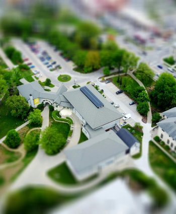 Aerial view of campus with green landscaping and parking, Manhattan, KS
